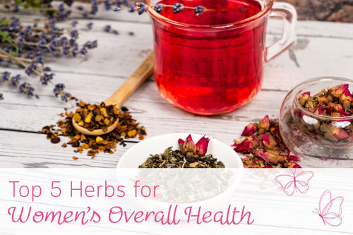Herbal tea setup with a red tea-filled glass mug, dried herbs, and flowers on a wooden table, labeled “Top 5 Herbs for Women’s Overall Health.”