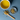 A cup of Organic Chamomile Tea beside a wooden spoon and small dish of dried chamomile flowers on a blue surface, showcasing a calm and minimal aesthetic.