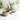 Cup of Organic Joint Health Tea in a floral-patterned ceramic teacup with matching teapot and a bowl of loose herbal tea leaves on a light wooden surface.