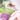 Full Leaf Tea Co. Organic Beauty Me Tea package with wooden spoon of loose leaf rooibos and mint blend, surrounded by pink flowers on a light marble background.