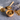 Loose leaf Organic Sleeping TranquiliTea blend with chamomile and lavender in a wooden bowl, with a bamboo spoon, tea bag, and dried lavender flowers on a gray stone surface.