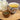 Tea cup with floral design and flowers, placed on a wooden surface.