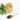 Glass of iced tea with tea leaves and a wooden spoon on a white background