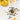 Jasmine pearls on a wooden spoon with a cup of tea and flowers on a white surface