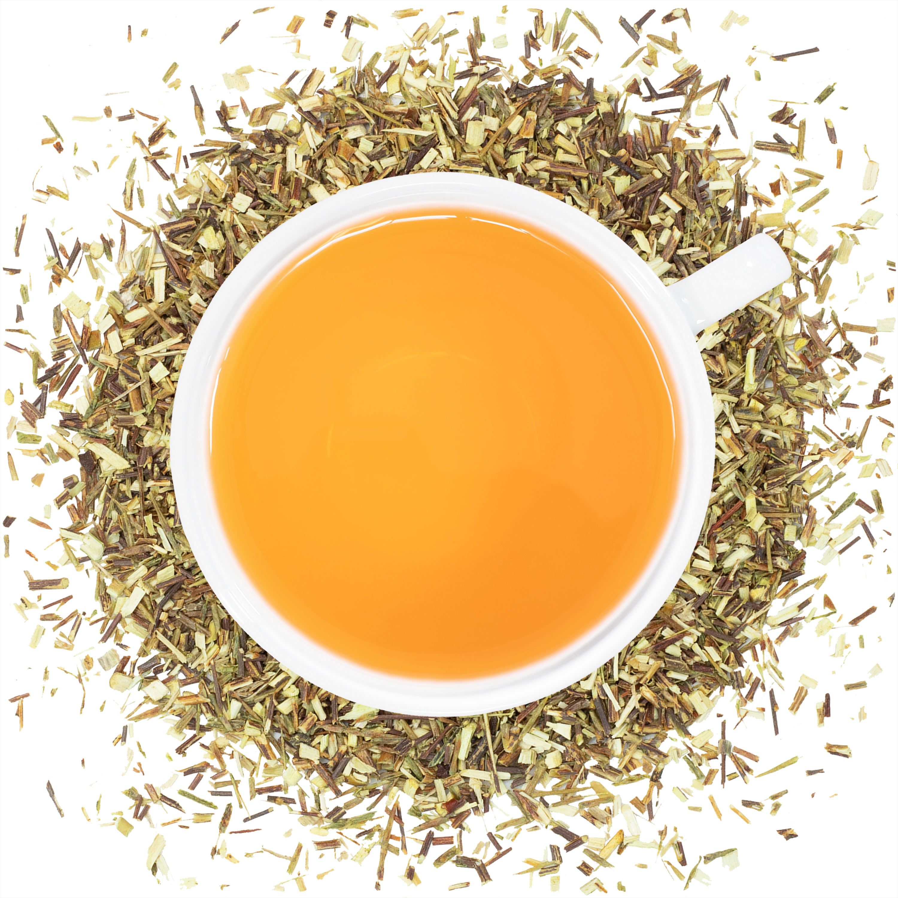 A white mug filled with Green Rooibus tea with green rooibos herbs spread around the mug. 
