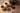 Tea cups, teapot, and oolong tea leaves on a wooden surface