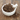 Dried black cohosh roots in a white mortar and pestle on a wooden surface.