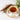 Teacup with floral design filled with tea, cinnamon stick, and herbs on a light background