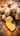 Fresh ginger root with several slices cut to reveal its yellow interior, displayed on a rustic wooden surface.