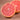 Close-up of a halved grapefruit on a wooden surface