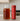 Red container with Full Leaf Tea Co branded on it and glass pitcher with tea on a kitchen counter
