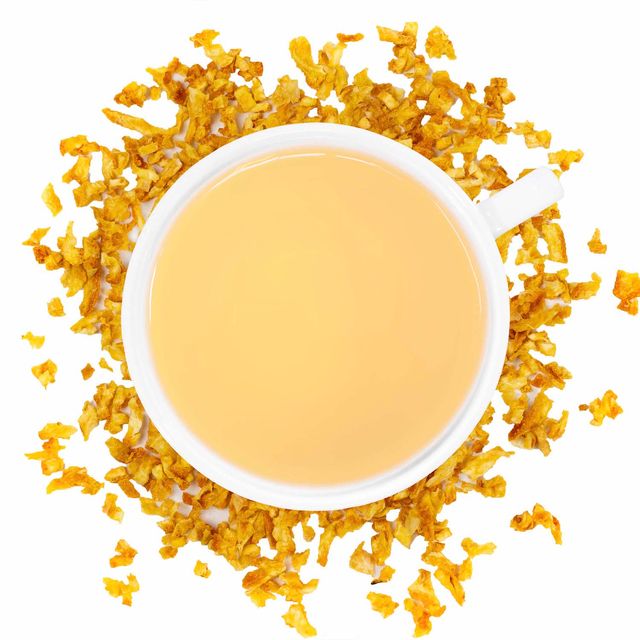 A white cup of Organic Orange Peel tea surrounded by the ingredient.