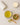Mug of green tea with a bowl of gsenna leaf and a candle on a light surface